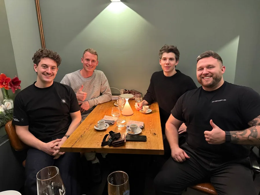 Four Web3 Factory team members sharing a meal in Hamburg
